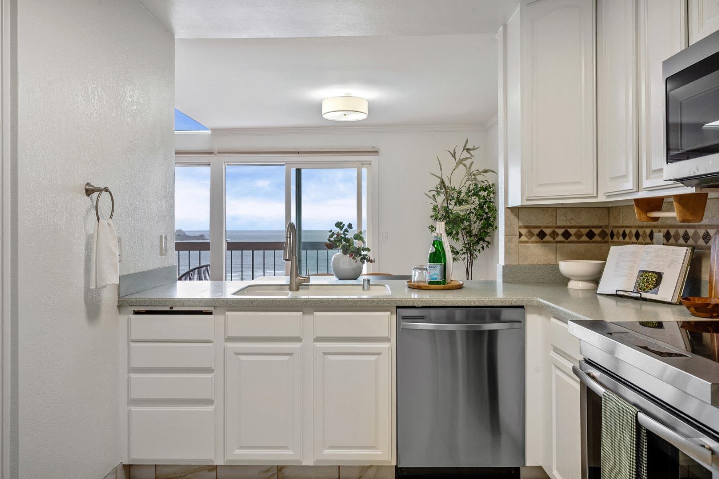445 Roberts Road Pacifica, CA 94044 - Photo 15 of 40 a kitchen with white cabinets and sink