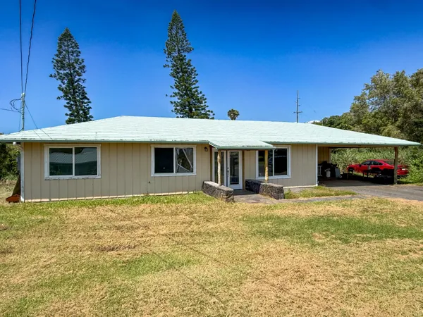 a front view of a house with yard porch and outdoor seating