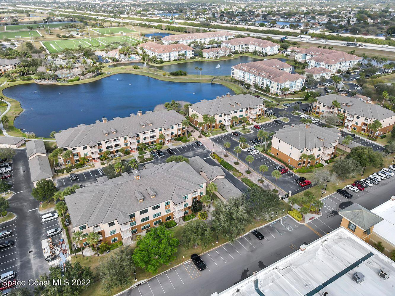 6460 Borasco Drive, Unit 1902 Melbourne, FL 32940 - Photo 18 of 36 an aerial view of a city with lots of residential buildings ocean and boats