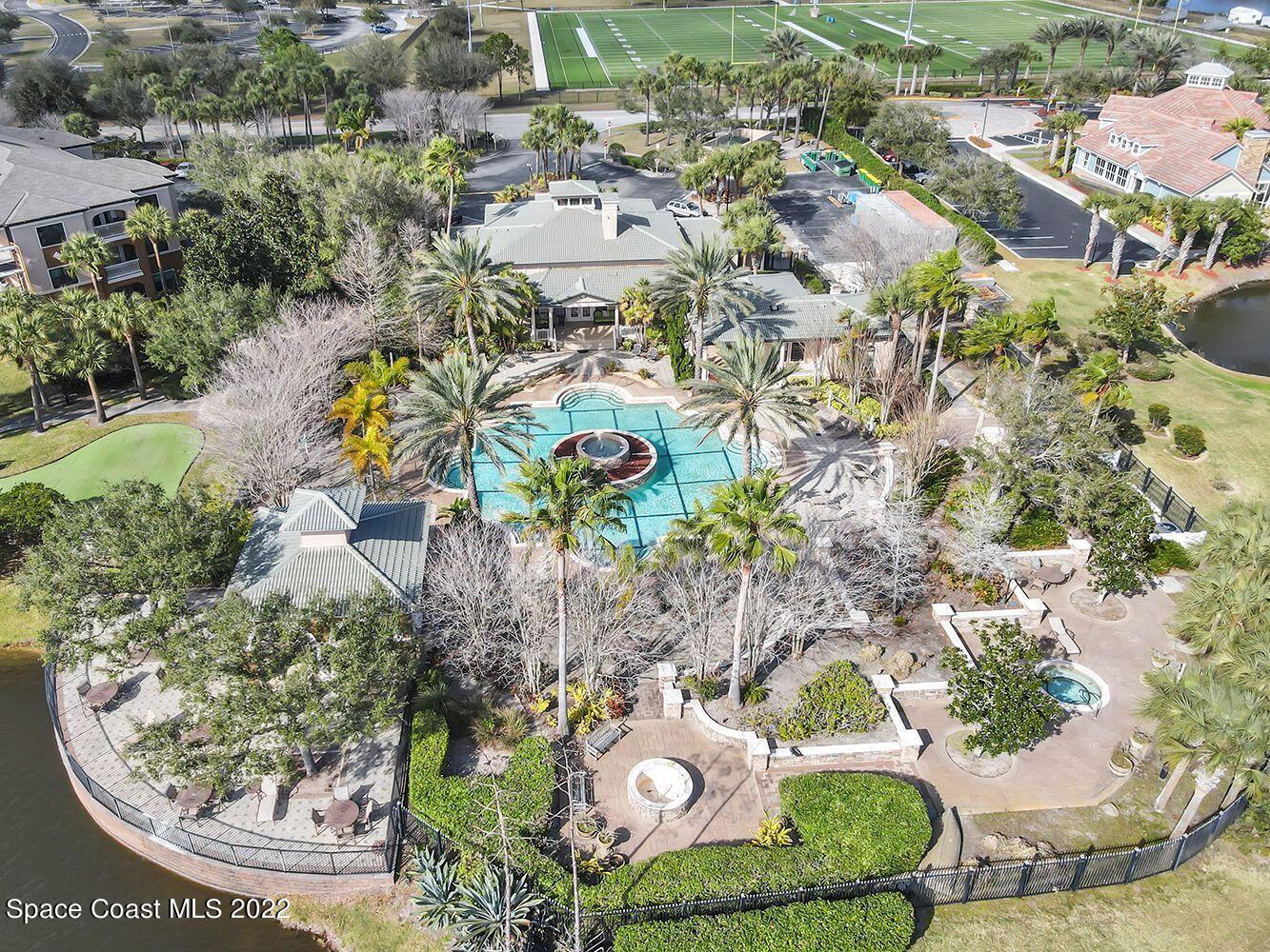 6460 Borasco Drive, Unit 1902 Melbourne, FL 32940 - Photo 29 of 36 an aerial view of a house with a yard and lake view