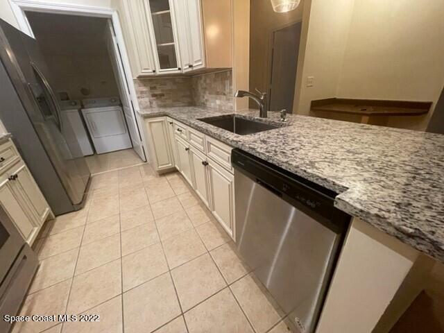 6460 Borasco Drive, Unit 1902 Melbourne, FL 32940 - Photo 5 of 36 a kitchen with granite countertop a sink and a stove
