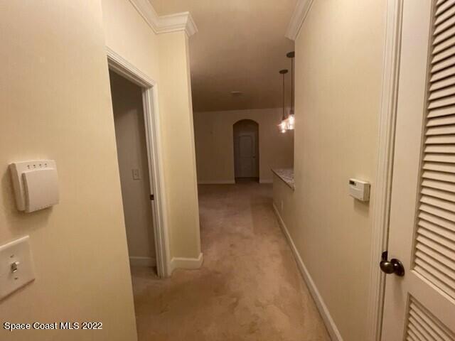 6460 Borasco Drive, Unit 1902 Melbourne, FL 32940 - Photo 8 of 36 a view of a hallway with wooden shelves