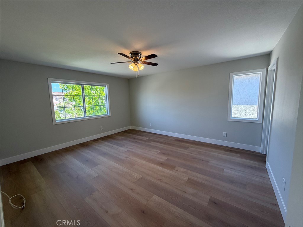 6 Hemingway Court Rancho Santa Margarita, CA 92679 - Photo 11 of 17 an empty room with windows chandelier fan and windows