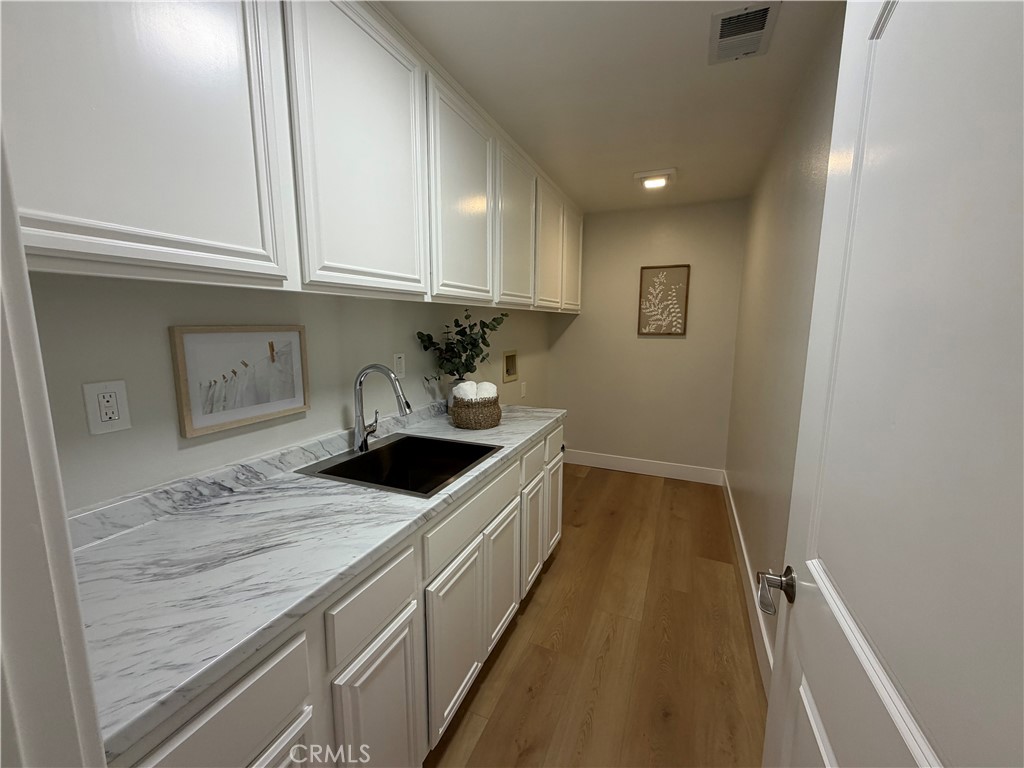 6 Hemingway Court Rancho Santa Margarita, CA 92679 - Photo 12 of 17 a kitchen with granite countertop a sink and cabinets
