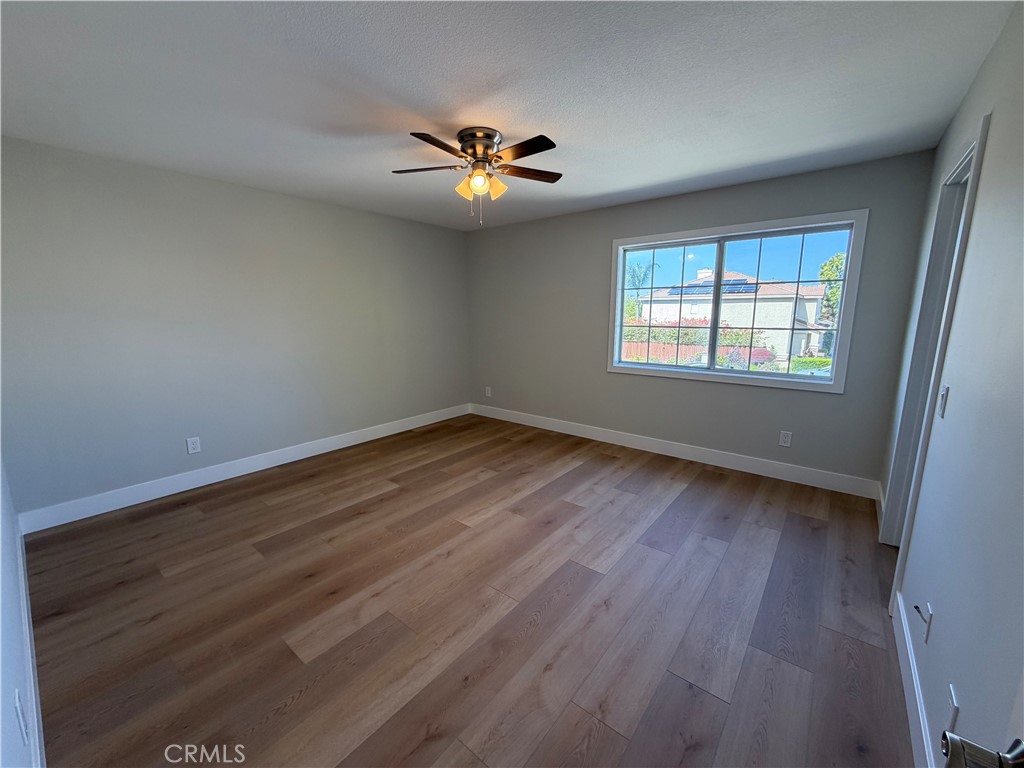 6 Hemingway Court Rancho Santa Margarita, CA 92679 - Photo 13 of 17 a view of an empty room with wooden floor and a window
