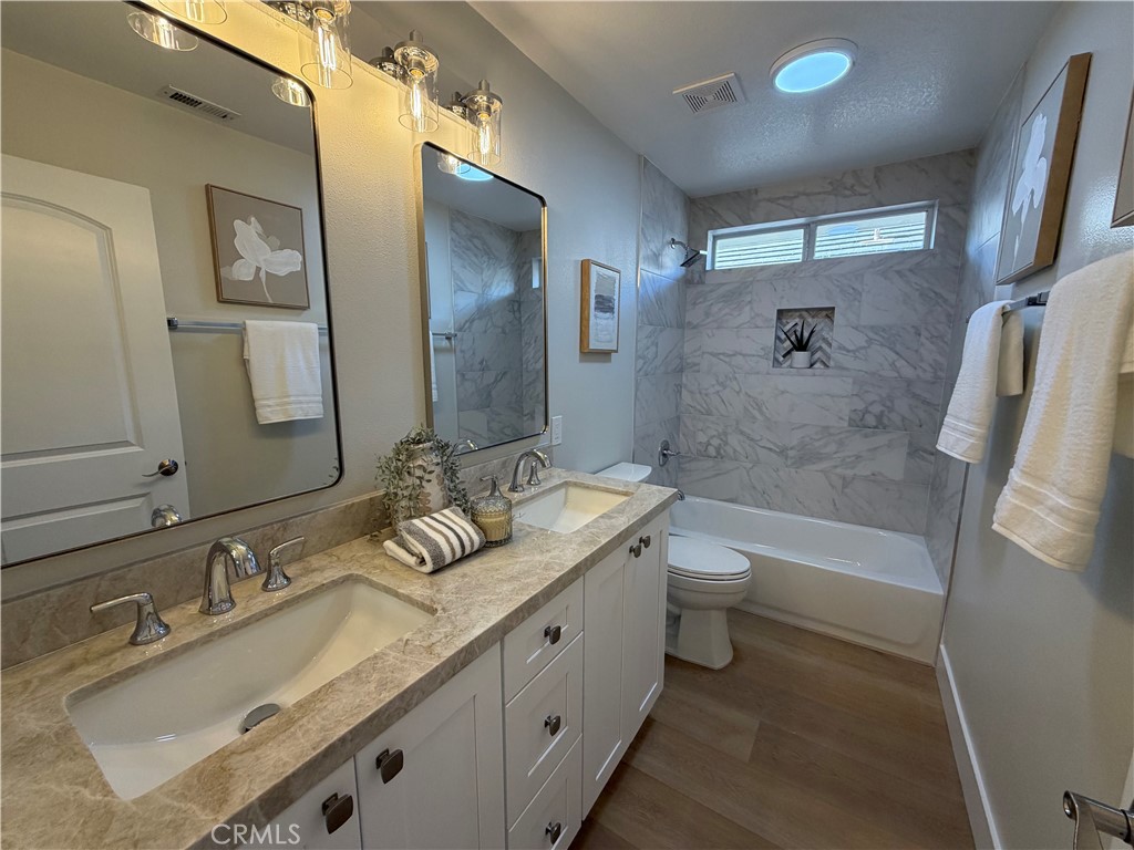 6 Hemingway Court Rancho Santa Margarita, CA 92679 - Photo 14 of 17 a bathroom with a granite countertop sink toilet and shower