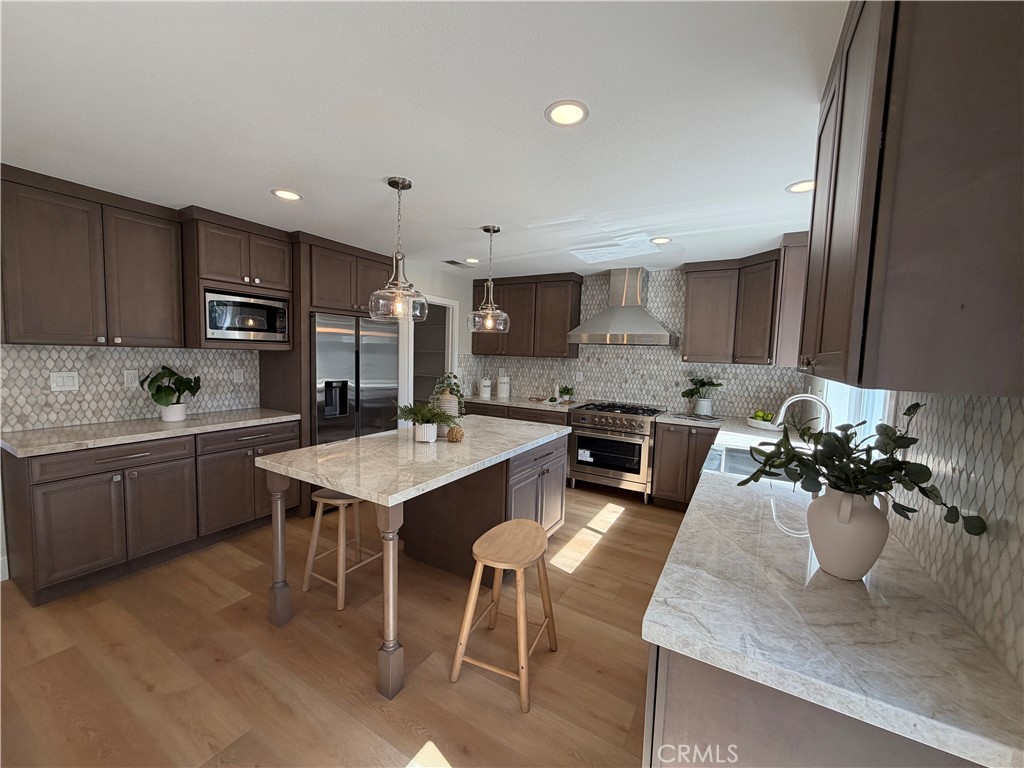 6 Hemingway Court Rancho Santa Margarita, CA 92679 - Photo 5 of 17 a kitchen with a sink a stove and chairs
