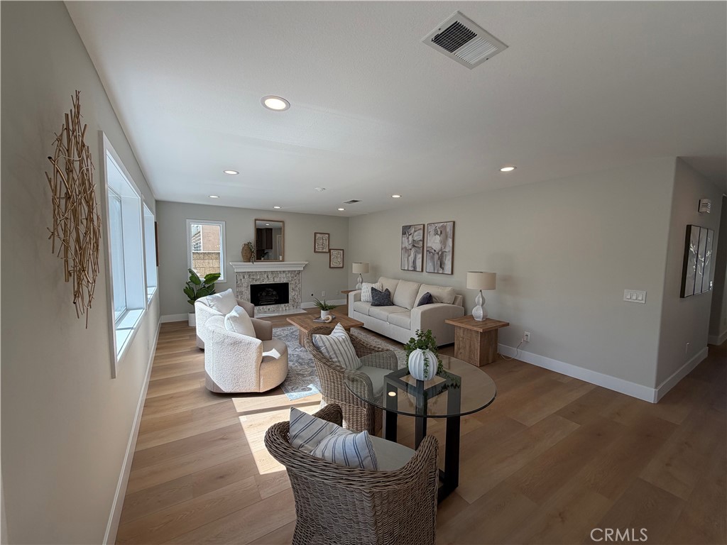 6 Hemingway Court Rancho Santa Margarita, CA 92679 - Photo 6 of 17 a living room with fireplace furniture and a wooden floor