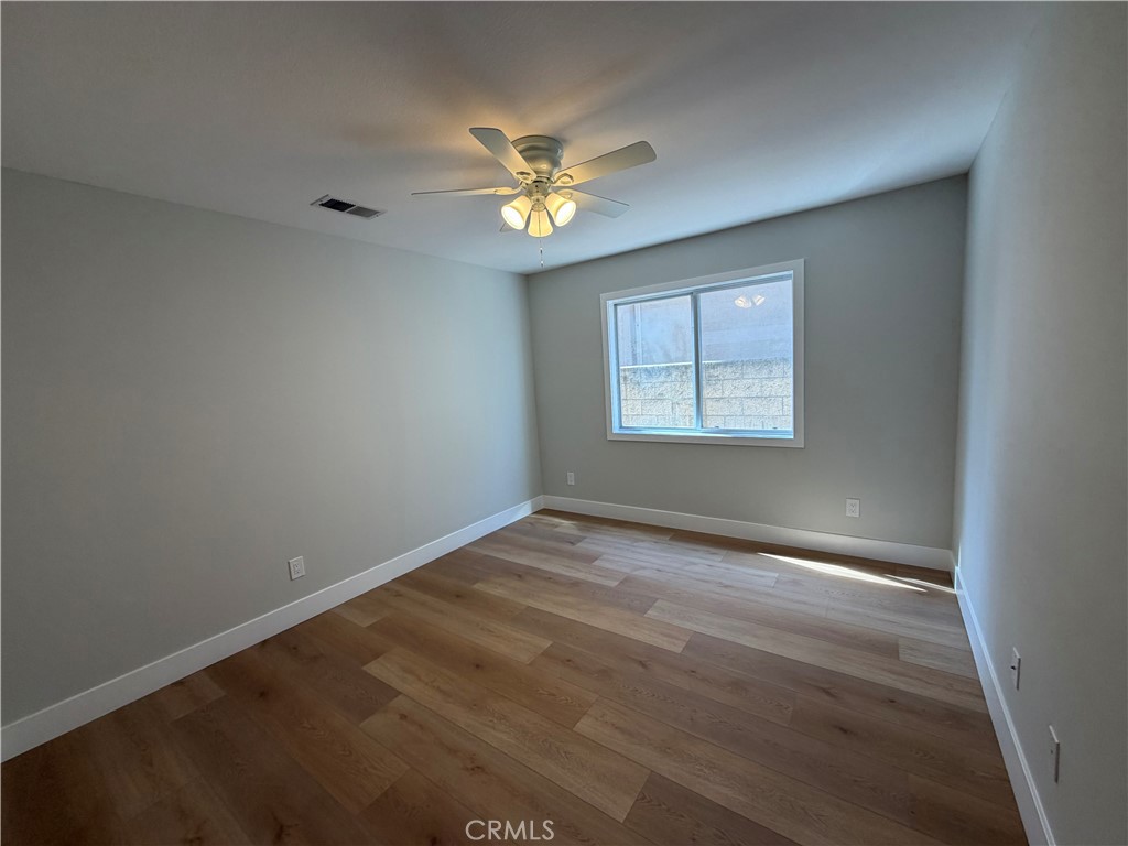 6 Hemingway Court Rancho Santa Margarita, CA 92679 - Photo 7 of 17 an empty room with windows and chandelier fan