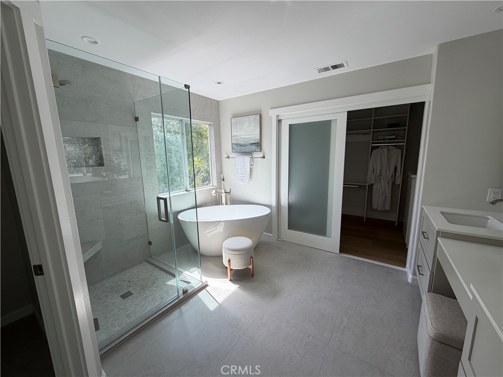 6 Hemingway Court Rancho Santa Margarita, CA 92679 - Photo 10 of 17 a bathroom with a double vanity sink toilet and shower