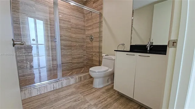 a bathroom with a toilet and a shower