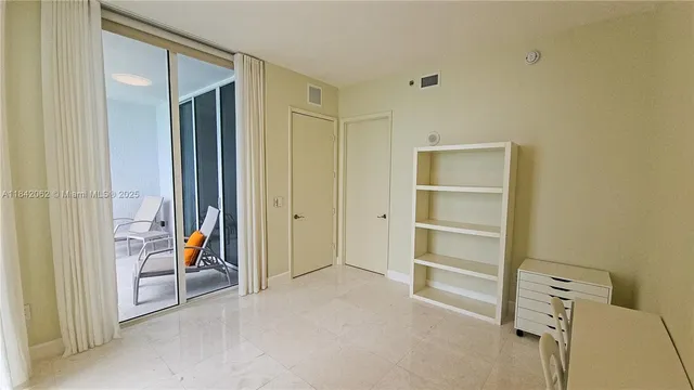 a white toilet sitting next to a sink and vanity