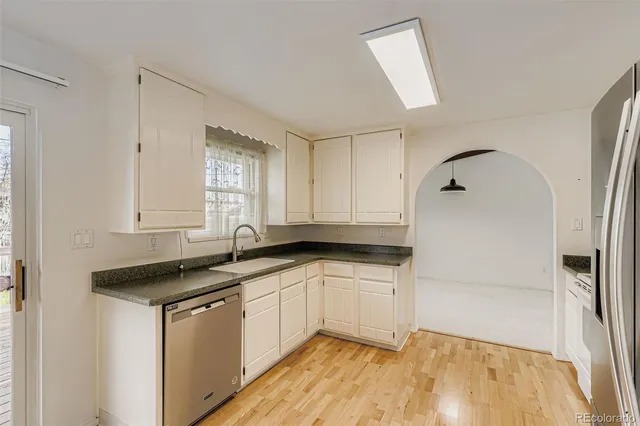 a kitchen with granite countertop a sink and cabinets
