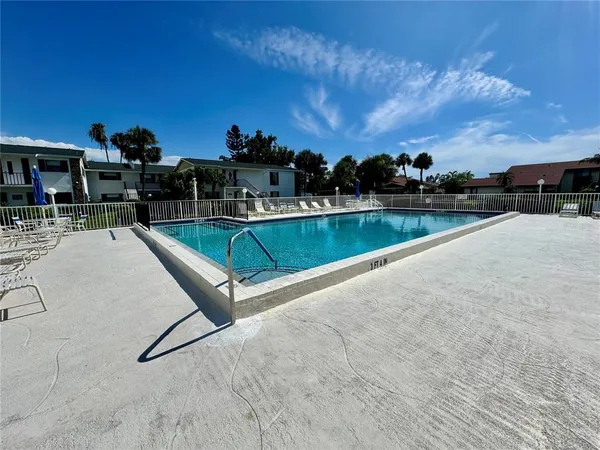 a view of a swimming pool with a yard