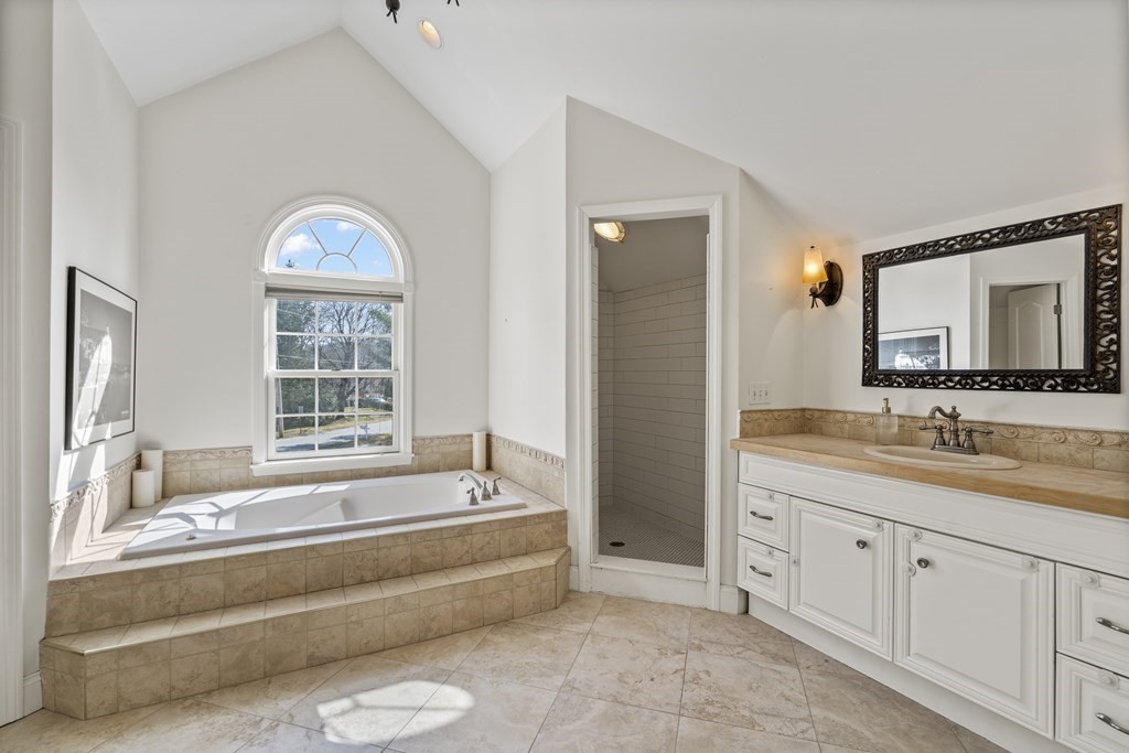 137 Randall Road Stow, MA 01775 - Photo 18 of 38 a spacious bathroom with a tub sink and mirror