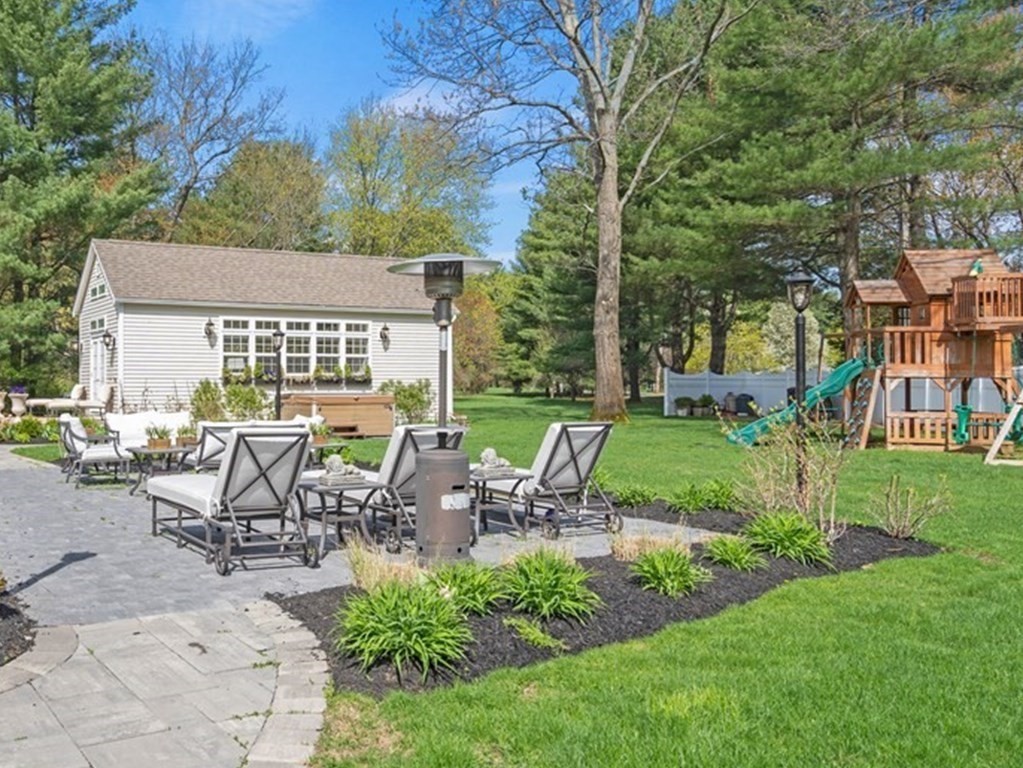 137 Randall Road Stow, MA 01775 - Photo 3 of 38 a view of a patio with table and chairs potted plants and large tree