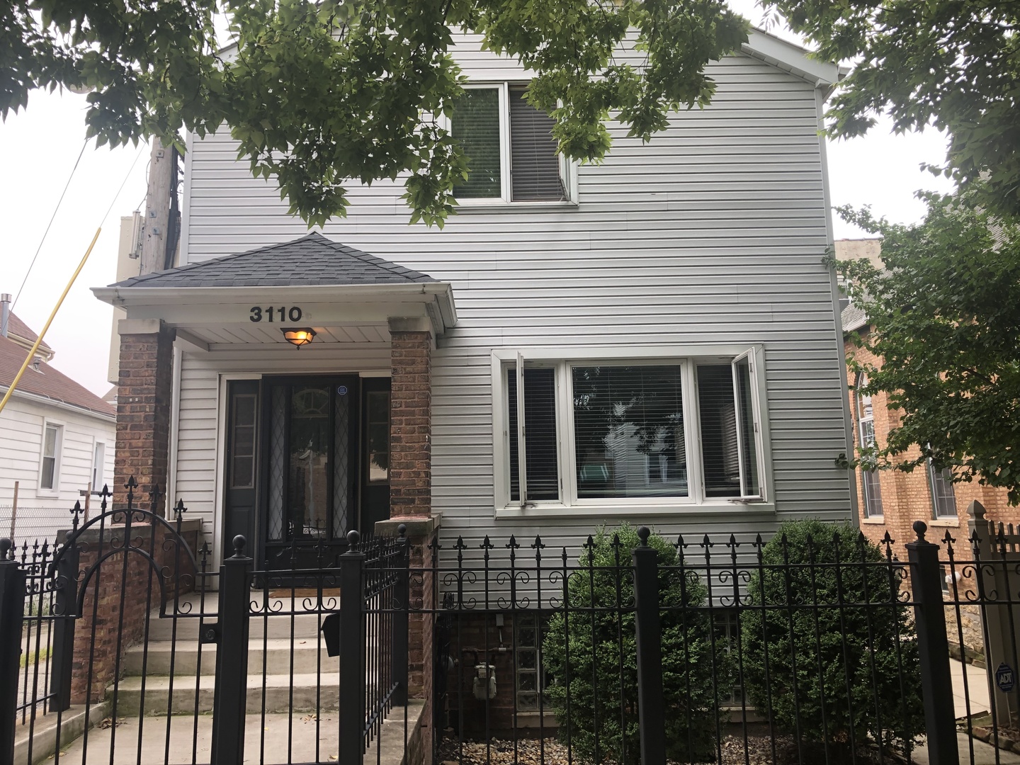 3110 South Racine Avenue Chicago, IL 60608 - Photo 1 of 23 a front view of a house with a garden
