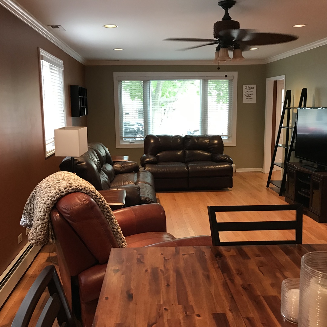 3110 South Racine Avenue Chicago, IL 60608 - Photo 2 of 23 a bedroom with furniture and a flat screen tv