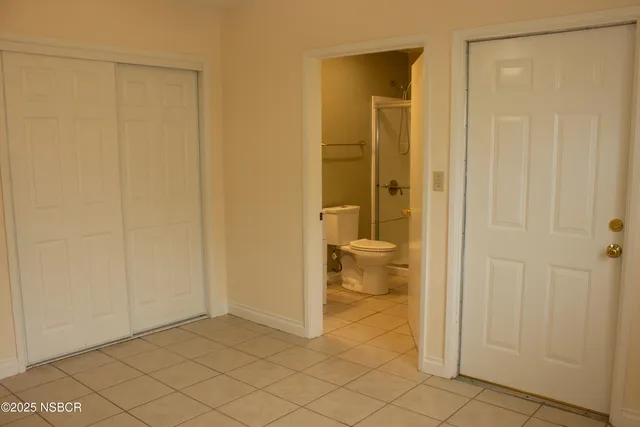 a bathroom with a shower and a toilet