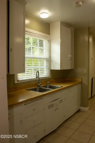 a kitchen with a sink and cabinets