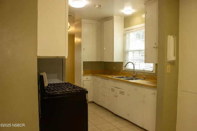 a kitchen with a sink and a refrigerator