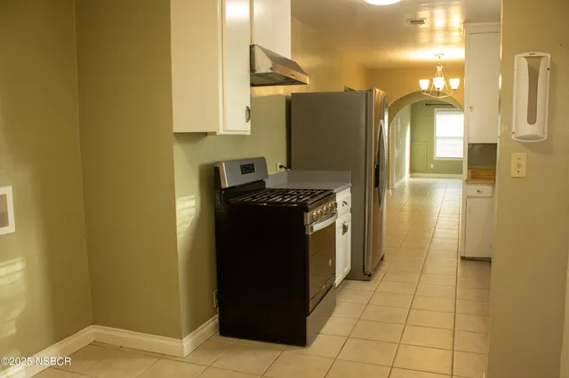 a kitchen with a refrigerator and a stove