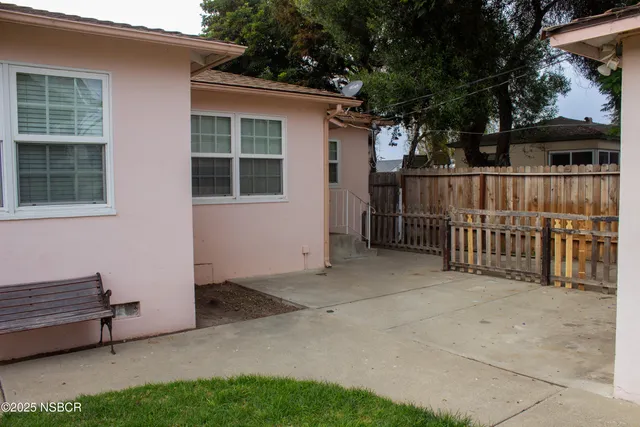 a view of backyard with deck and outdoor seating