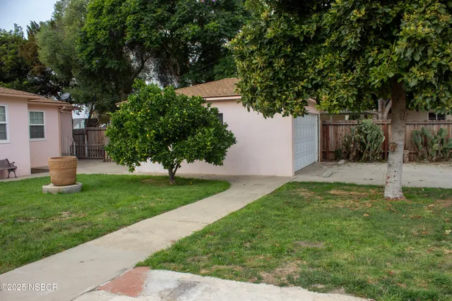 a view of a house with a yard and plants