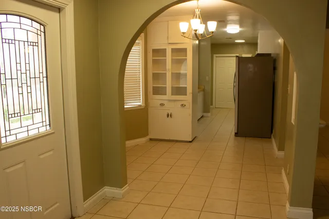 a view of a hallway with wooden shelves