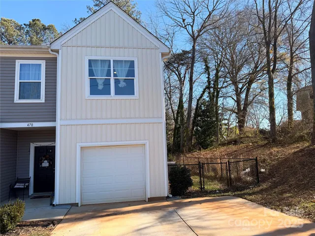 a view of backyard of house and trees