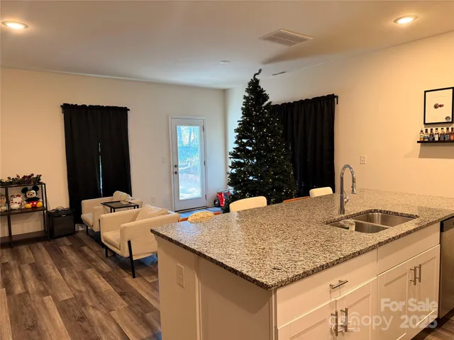 a bedroom with a granite countertop sink and a dresser