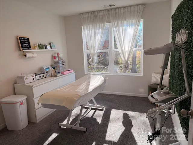 a dining room with furniture and a window