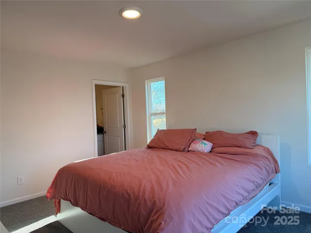 a bedroom with a bed and window