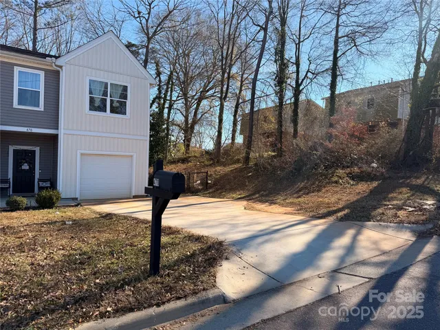 a street view with large trees