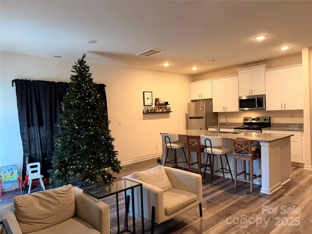 a living room with furniture and a piano