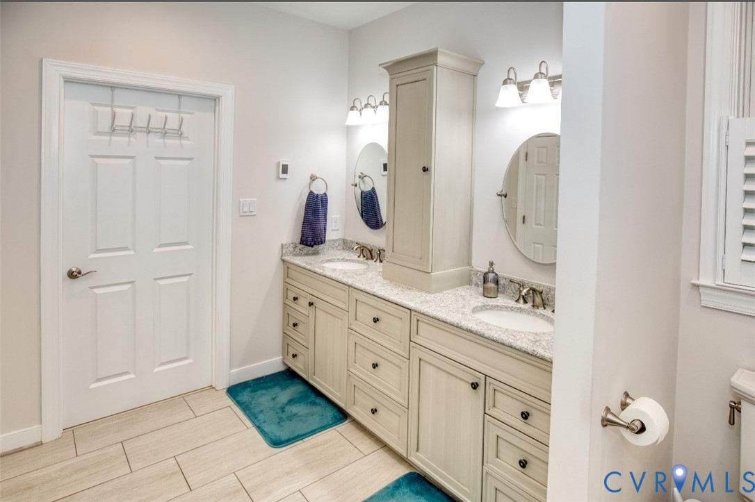 7075 Menzels Road Toano, VA 23168 - Photo 31 of 50 Double vanity with undermount sinks, light-toned c