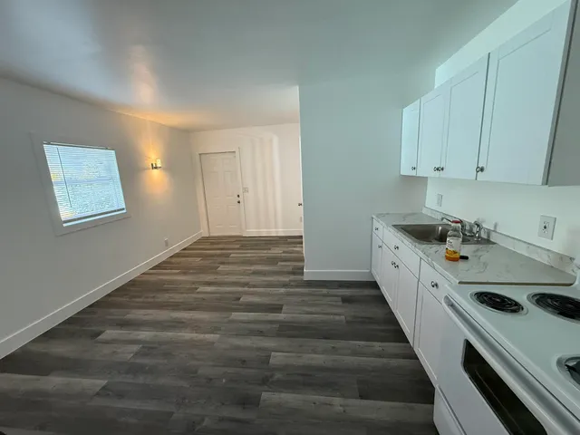 a room with a bed and cabinets