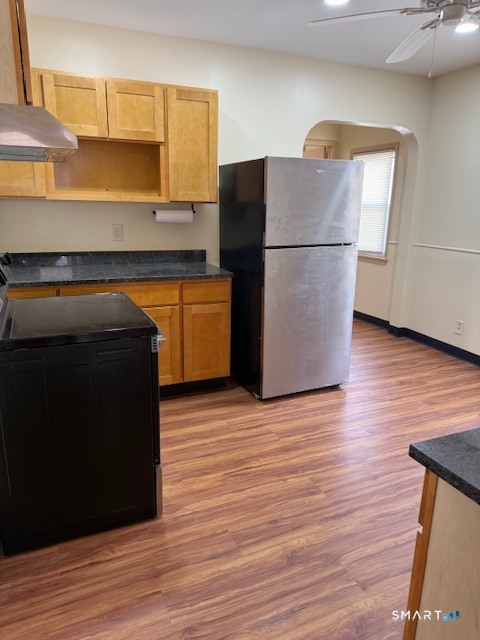 1694 Broad Street, Unit 2 Hartford, CT 06106 - Photo 8 of 10 a kitchen with a refrigerator and a wooden floor