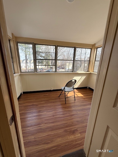 1694 Broad Street, Unit 2 Hartford, CT 06106 - Photo 10 of 10 a view of an empty room with wooden floor and a window