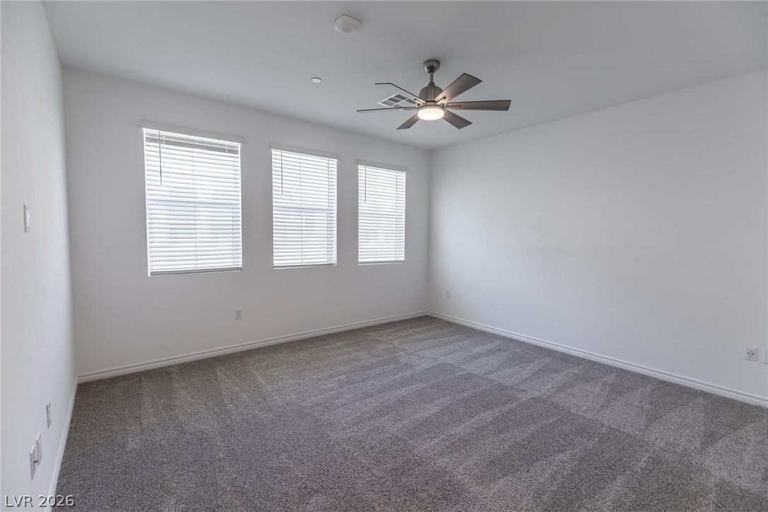 2555 Hampton Road, Unit 8206 Henderson, NV 89052 - Photo 11 of 35 This spacious room features ample natural light and a modern ceiling fan for comfort.