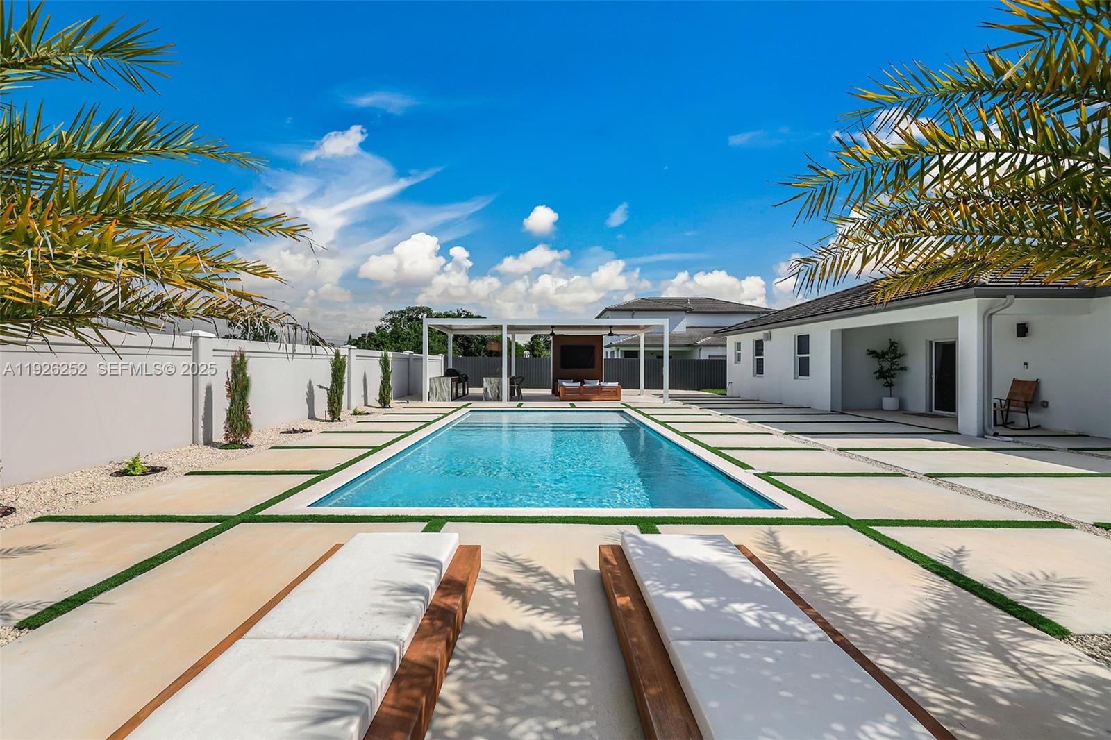 a view of a house with pool and sitting area