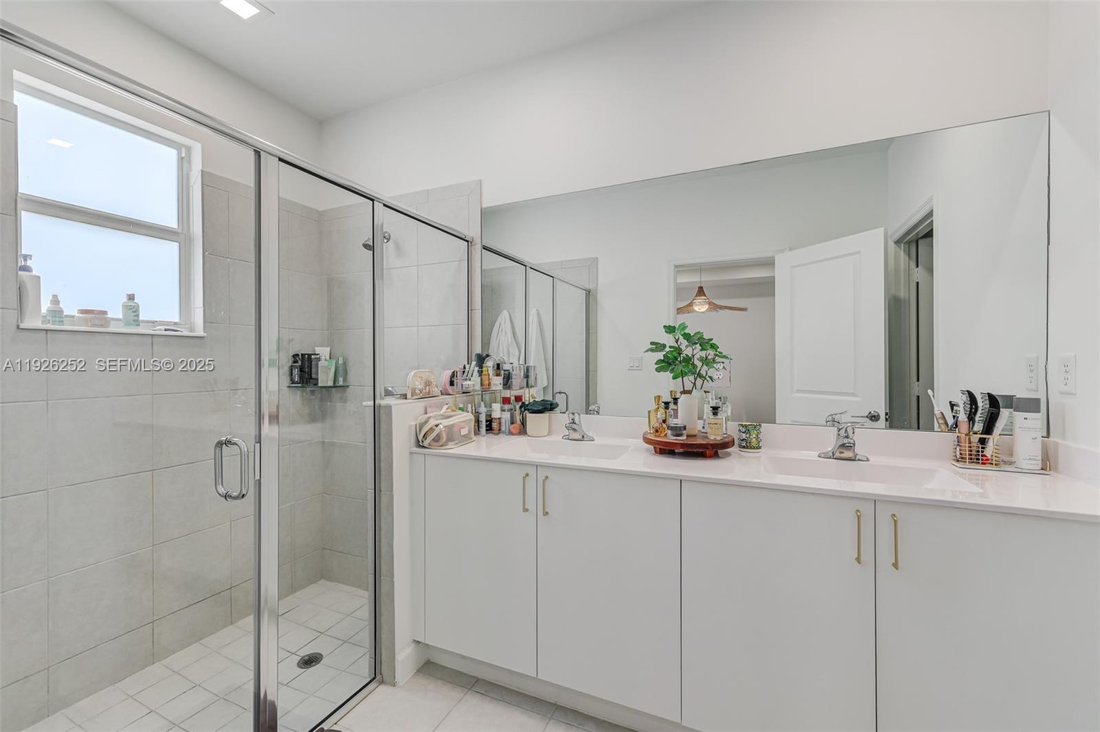16753 Southwest 290th Street Homestead, FL 33030 - Photo 12 of 29 a bathroom with a double vanity sink and mirror
