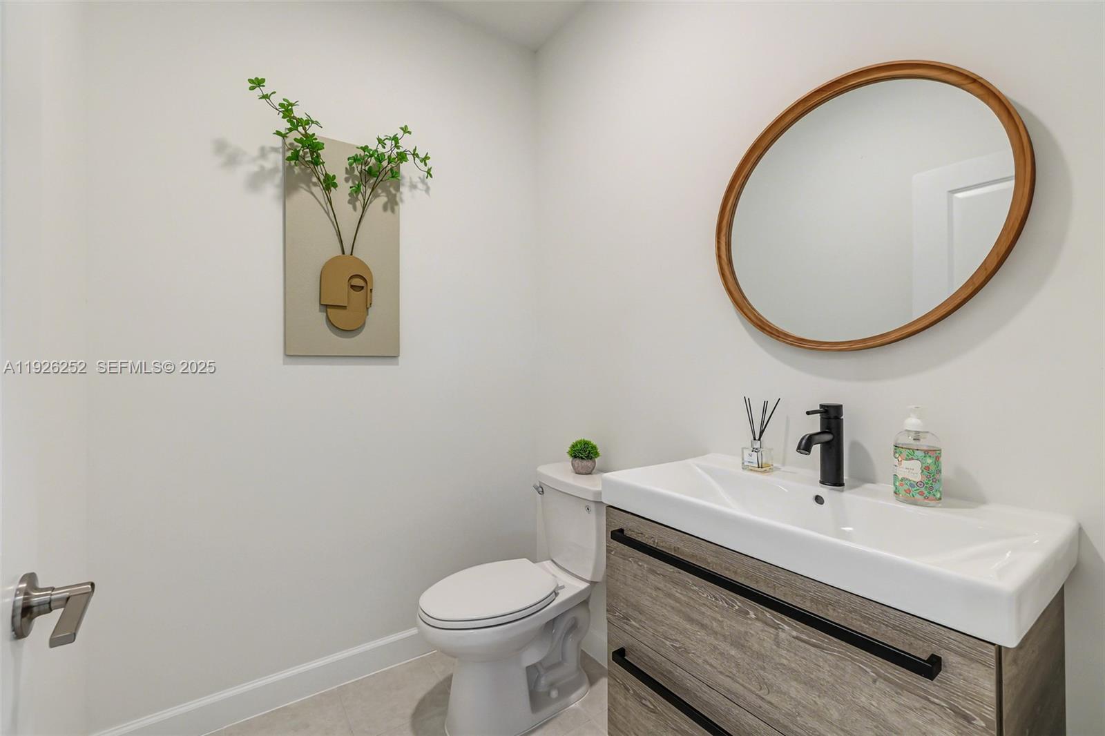 16753 Southwest 290th Street Homestead, FL 33030 - Photo 17 of 29 a bathroom with a sink mirror and toilet