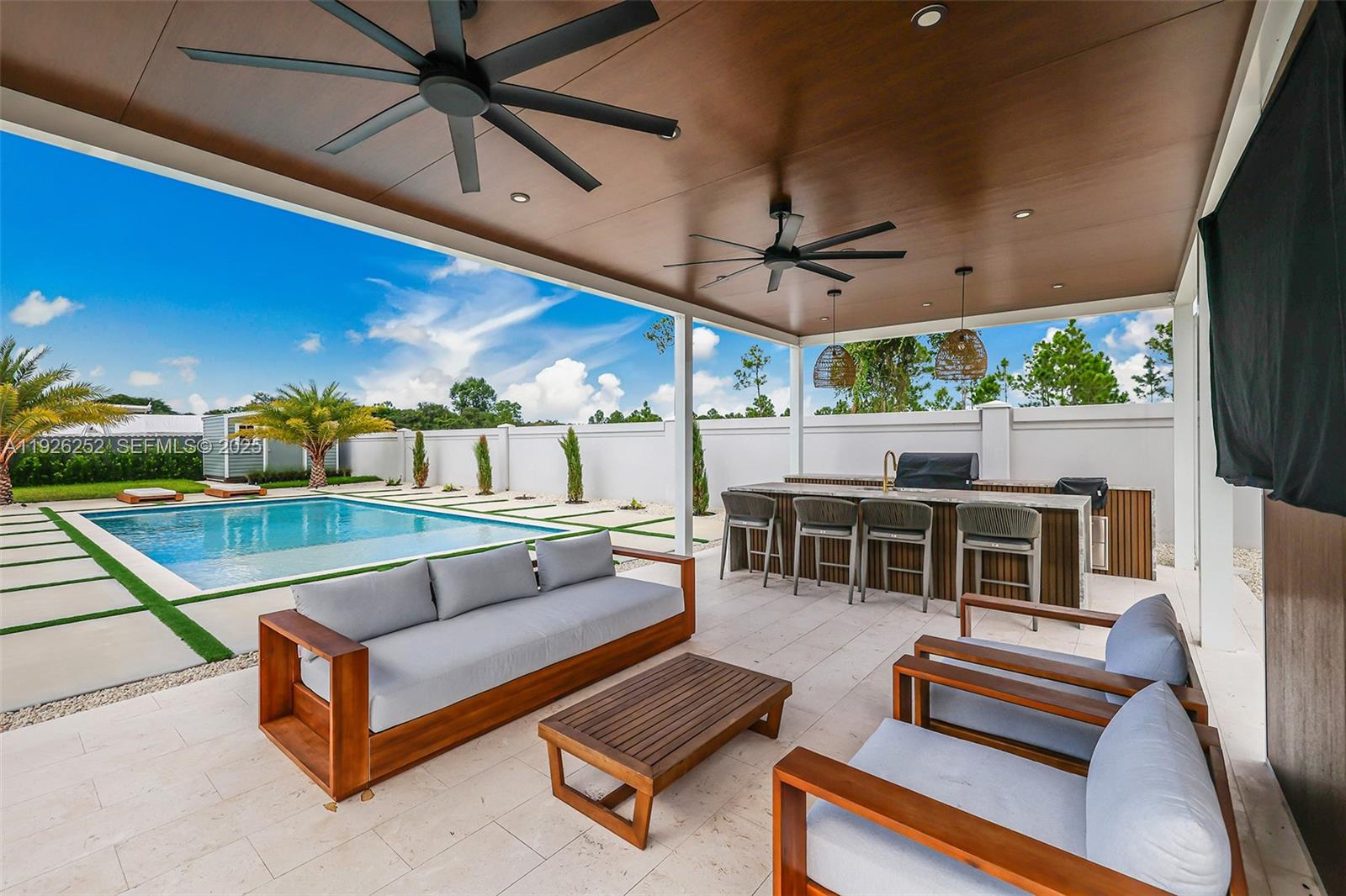 16753 Southwest 290th Street Homestead, FL 33030 - Photo 24 of 29 a outdoor living space with furniture and a fireplace