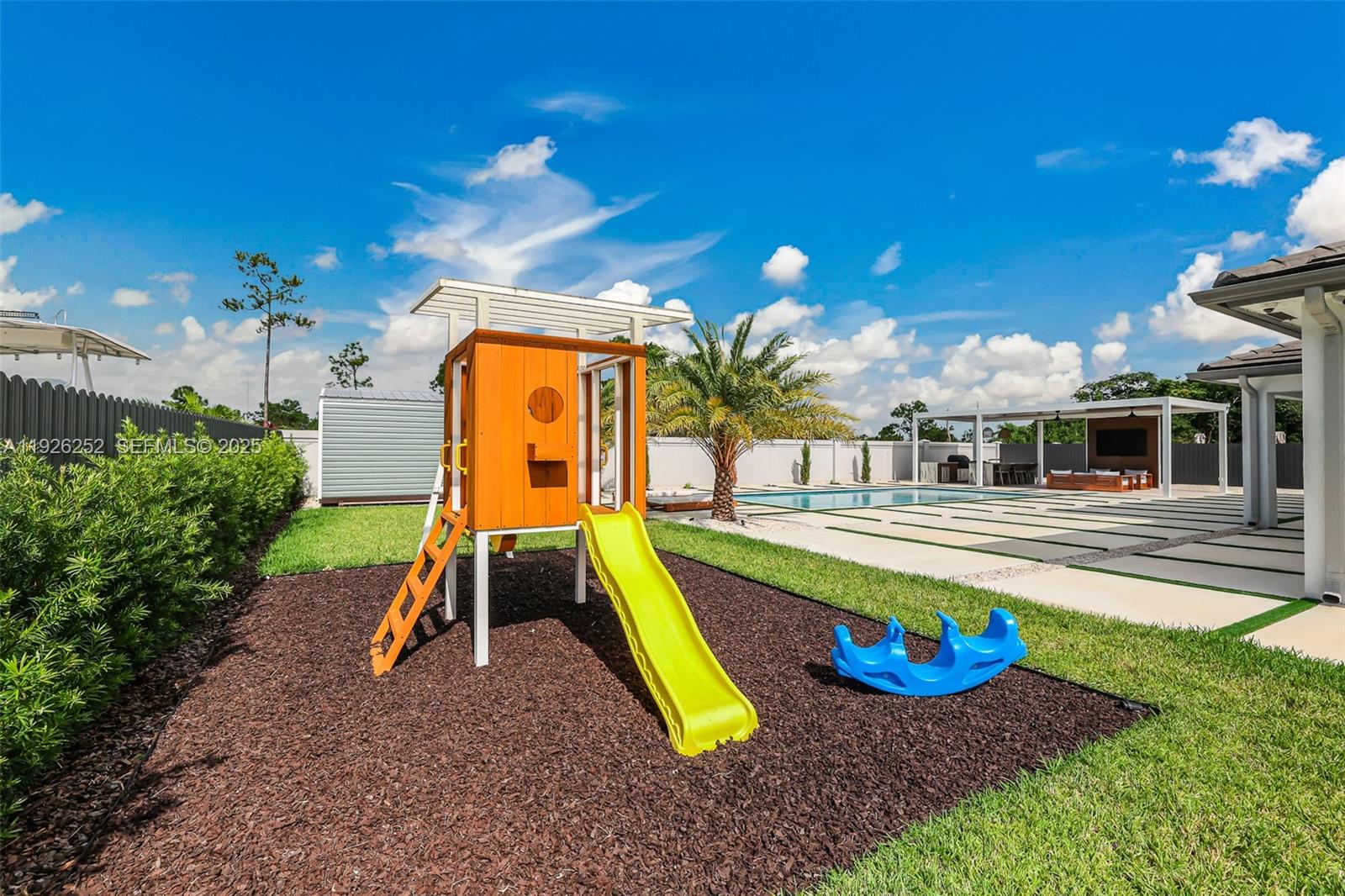 16753 Southwest 290th Street Homestead, FL 33030 - Photo 25 of 29 a view of a swimming pool with a yard and seating area