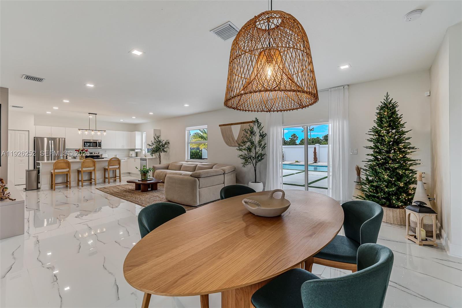 16753 Southwest 290th Street Homestead, FL 33030 - Photo 3 of 29 a kitchen with stainless steel appliances granite countertop a table chairs a sink and a counter top space