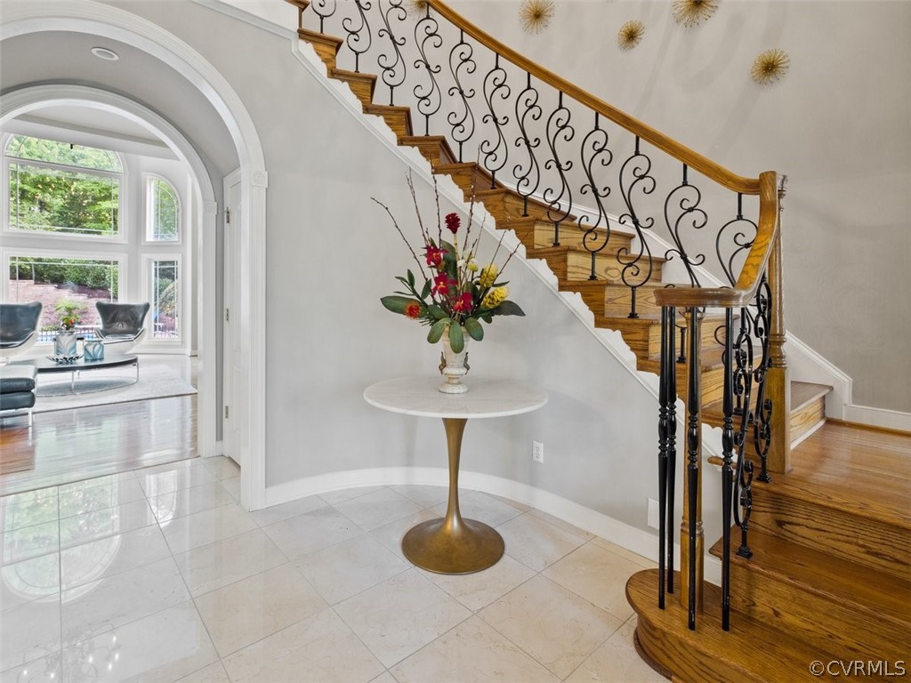 14207 Lander Road Midlothian, VA 23113 - Photo 3 of 21 A WOW 2 story entry with curved staircase, arch casement openings with direct views of the family room and pool.