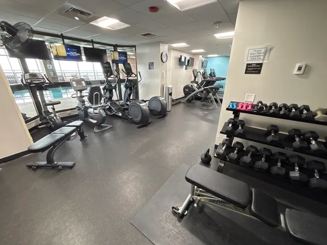 a room with gym equipment and lots of equipment