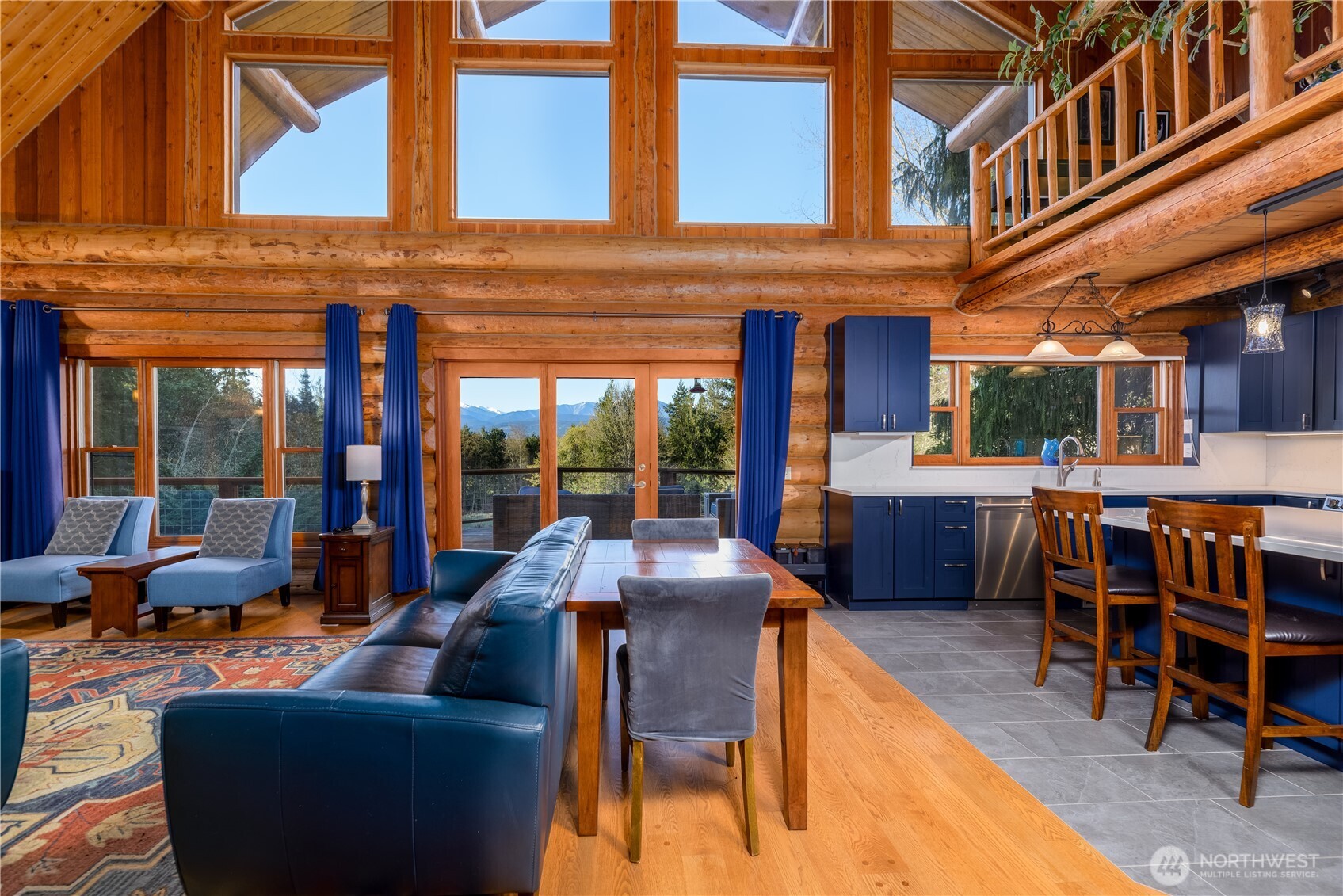 193 Snowberry Lane Sequim, WA 98382 - Photo 5 of 40 a view of a building with furniture and floor to ceiling windows