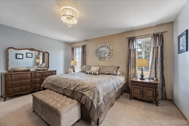 a bathroom with double vanity sink a mirror and a shower